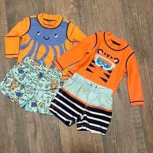 Two Carter’s swim trunks and rash guards